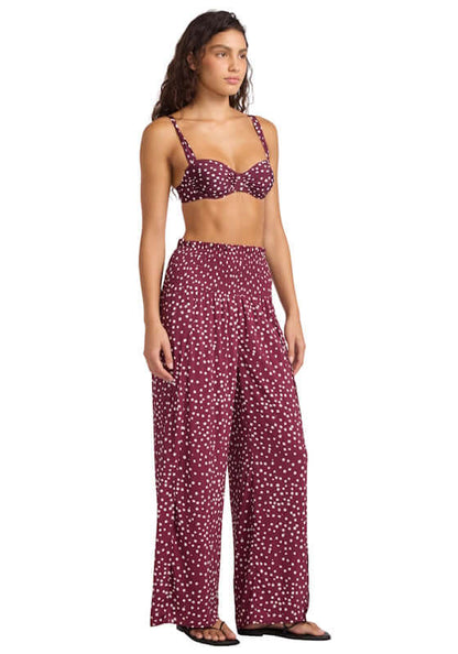 Dolce Dot Shirred Waist Beach Trouser by Seafolly, showcasing a model wearing burgundy trousers with white polka dots.