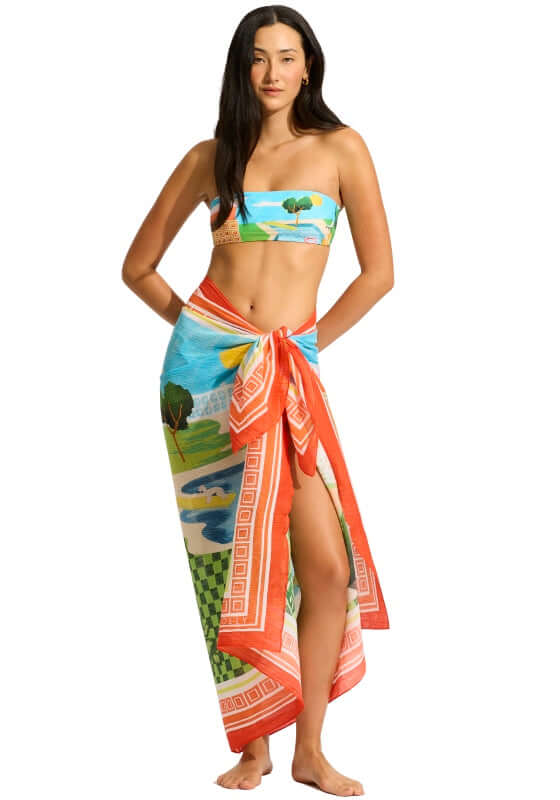 Sunset Sarong by Seafolly, model wearing a colorful aquatic print sarong tied at the waist with a slit.