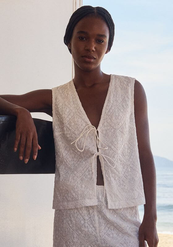 Bao Top Santorini White by Sundress, model in elegant spaghetti strap top with embroidered fabric.