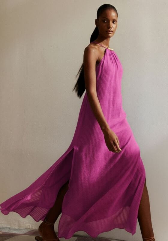 Lily Long Dress French Rose by Vix. Model showcases the elegant pink maxi dress with side slits and open back.